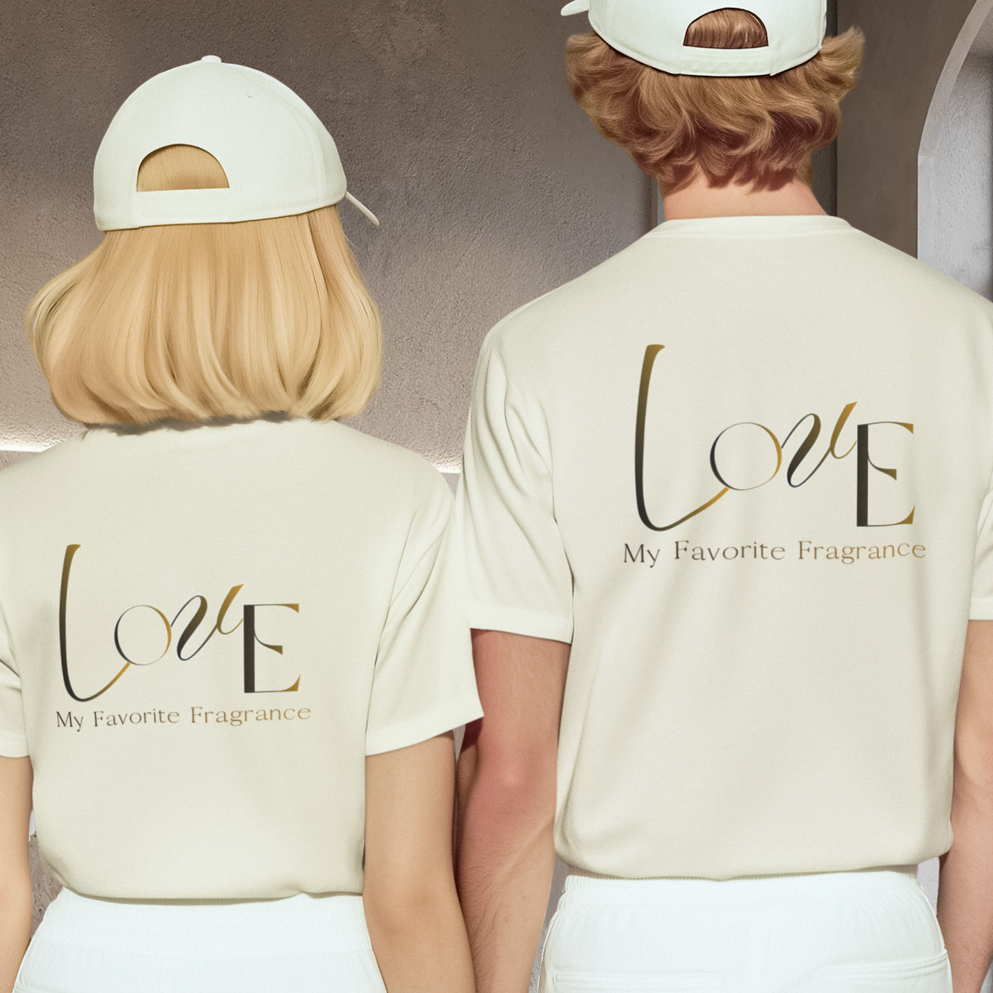 unisex 100% cotton t-shirt with graphic fashion stylised text ' Love my favorite fragrance' cream white color couple hand in hand stading wearing the same t-shirt and a white cap and white pants back view of the couple they are in interior grey background minimalist style
