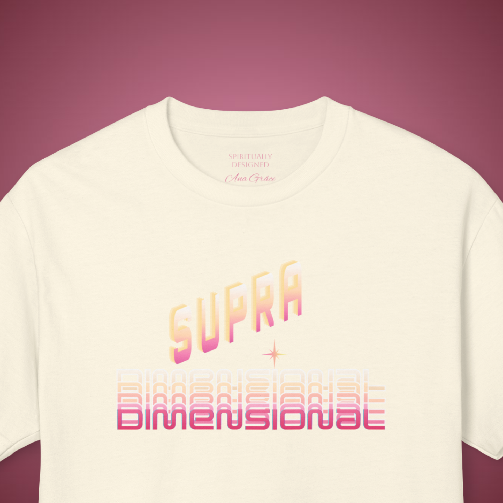 cosmic style white t-shirt with pastel colors printed with the inspirational saying "SUPRA dimensional" and a little star , the neck label is printed " spiritually designed" and "Ana Grâce" i pink , on a red burgundy background