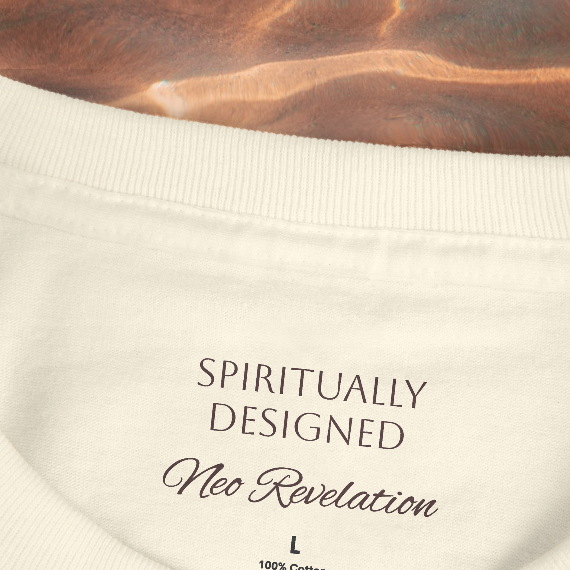 necklabel shirt close up view with the words printed ' spiritually designed' and 'neo revelation' in brown dark color L size on a brown spiritual background water lookalike